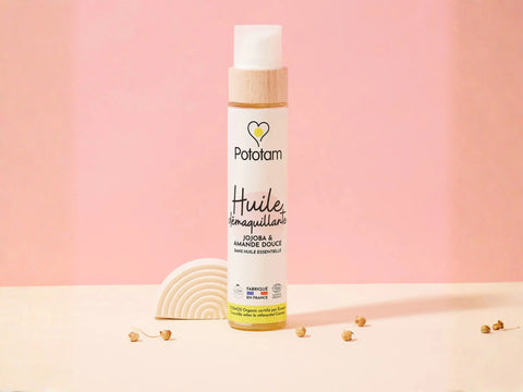 Huile démaquillante à la jojoba et à l'amande douce pour visage et corps, contenant des ingrédients nourrissants et doux.